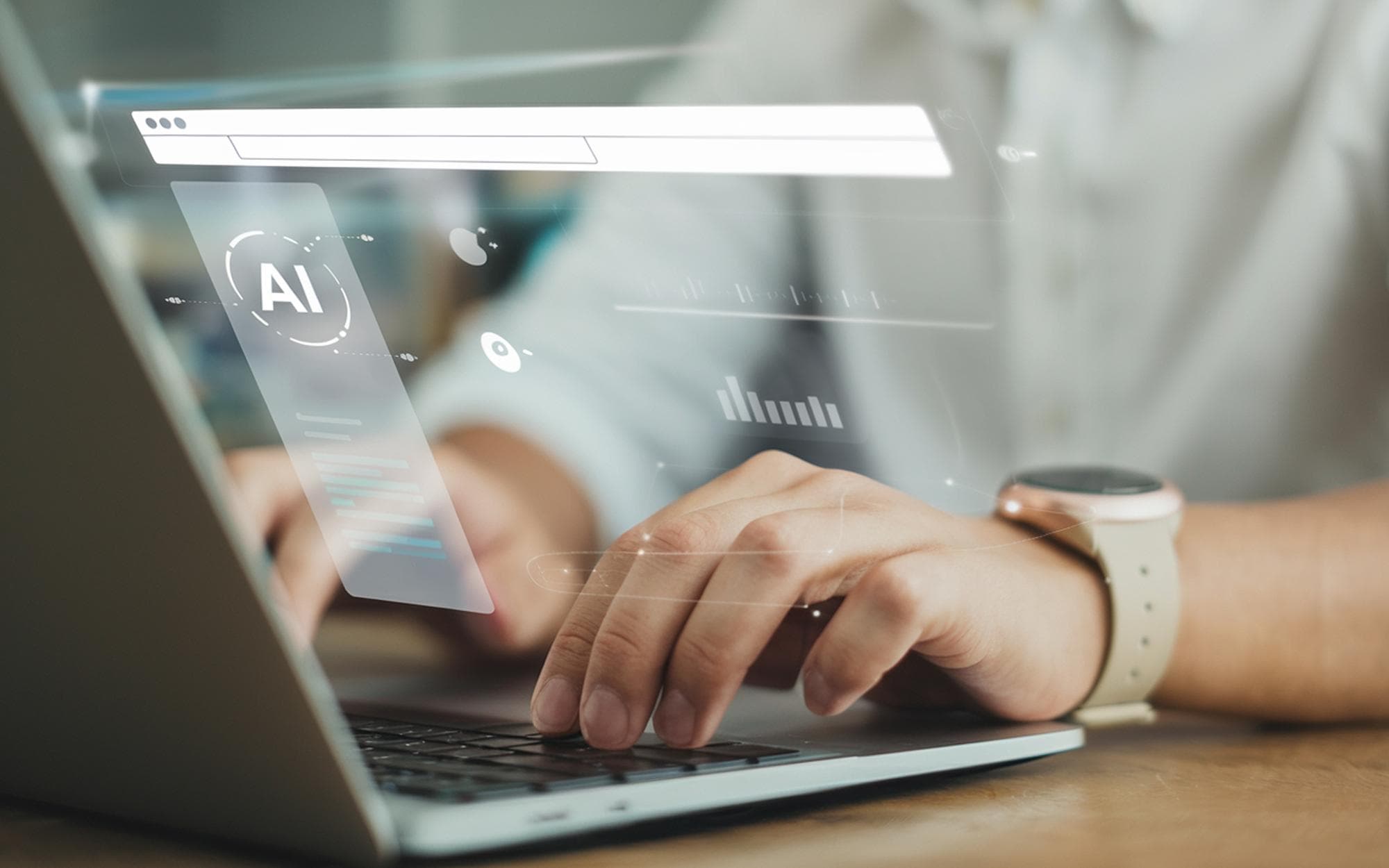 A person working on a laptop with an AI icon on the screen